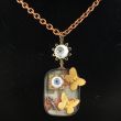 Verkocht Ketting Memories Vintage tinnen doosjemet poppenogen € 27,50